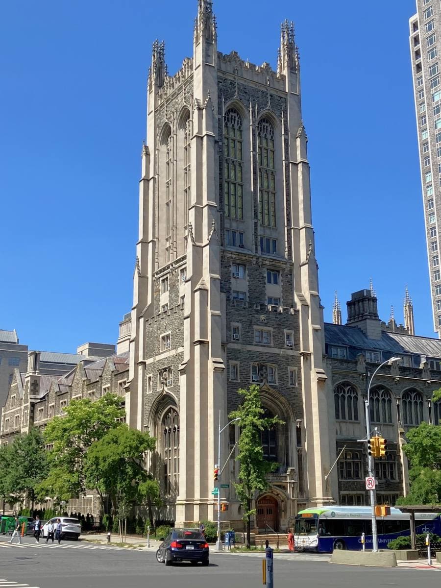 A Gothic stone tower over a street corner