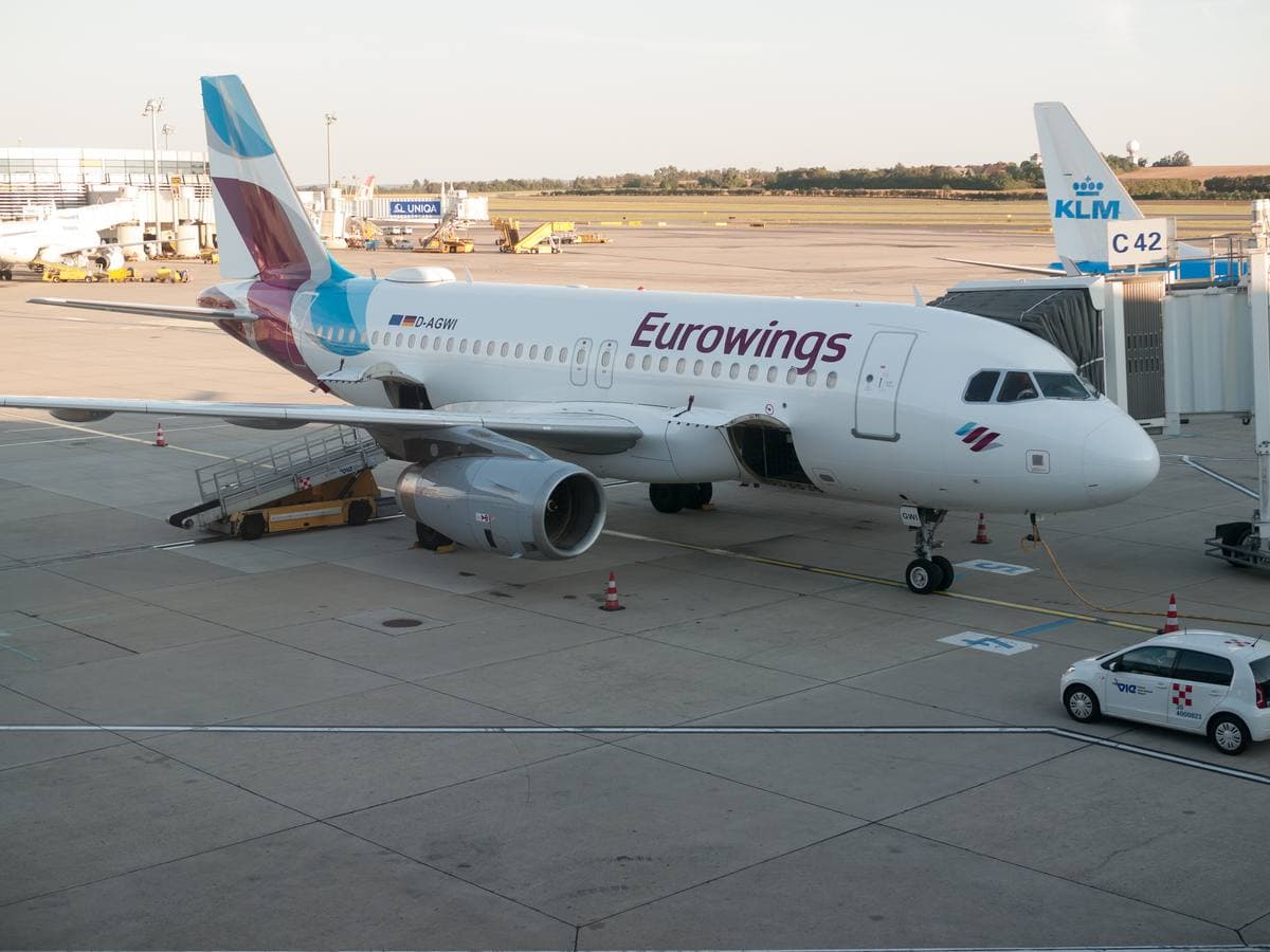 An airport apron with a tower and parked jets