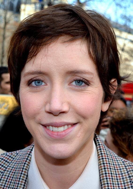 Sara Giraudeau, short dark hair, smiling, in a checked jacket