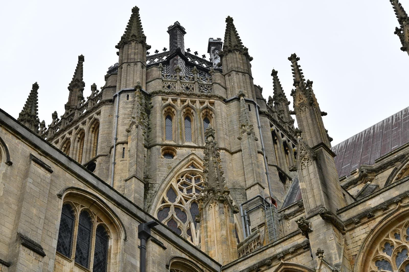 The carved stone octagon and pinnacles of Ely Cathedral against a pale sky