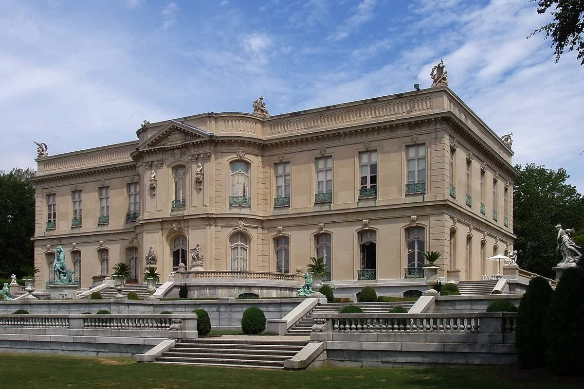 The Elms, a symmetrical pale limestone mansion seen across a wide lawn