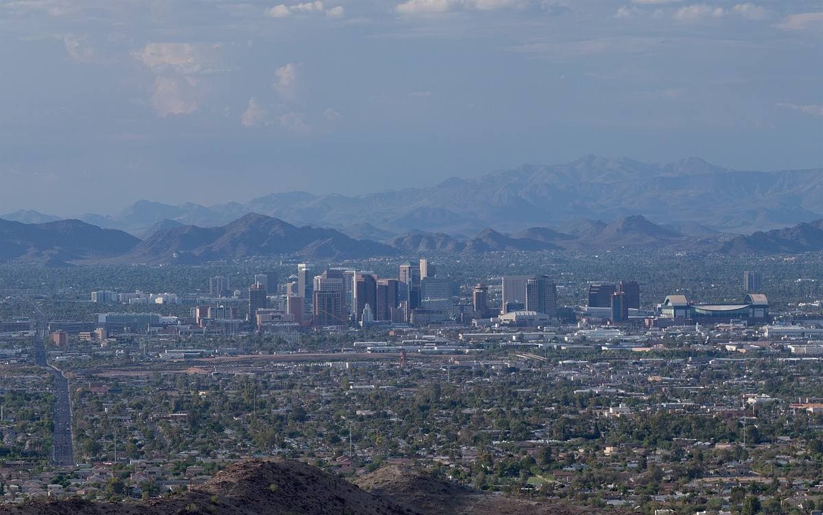 Office towers of downtown Phoenix against desert mountains