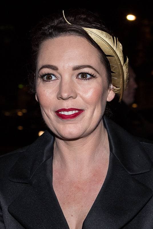 Olivia Colman smiling, in a dark dress