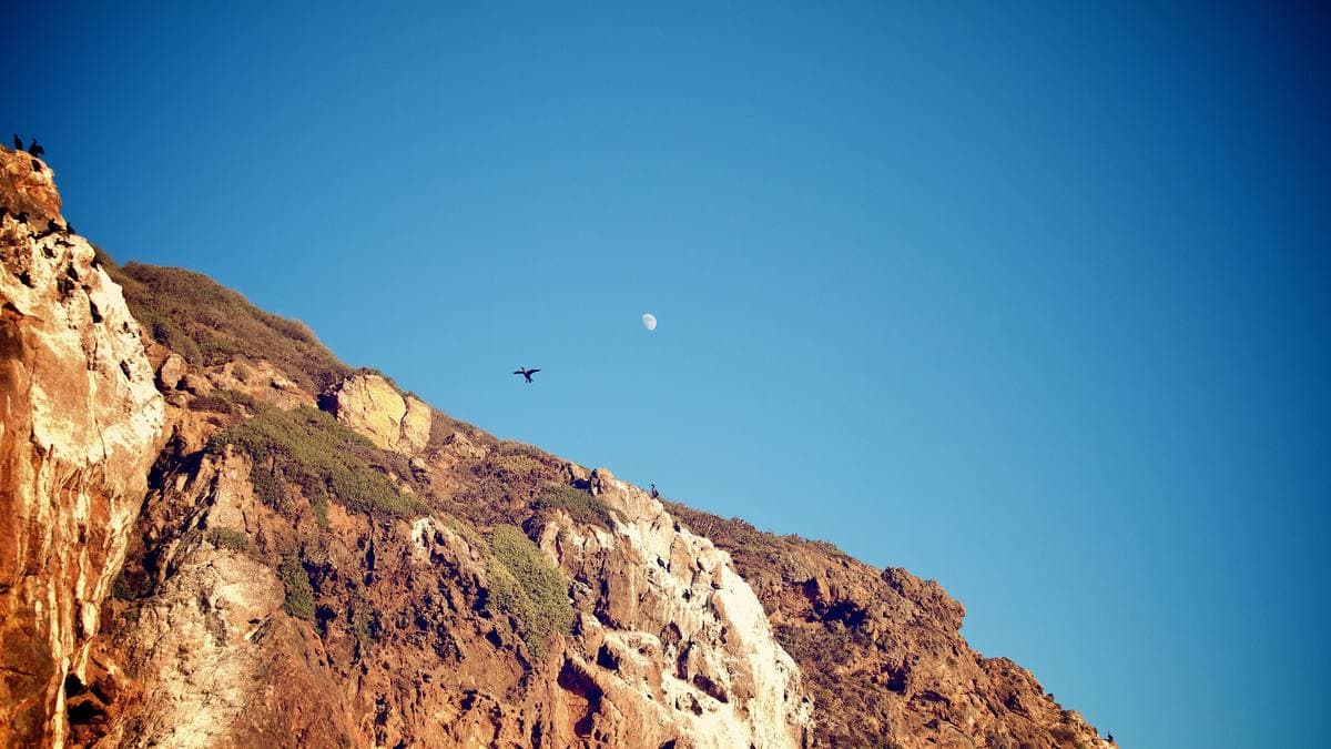 Golden sandstone cliffs under a deep blue sky