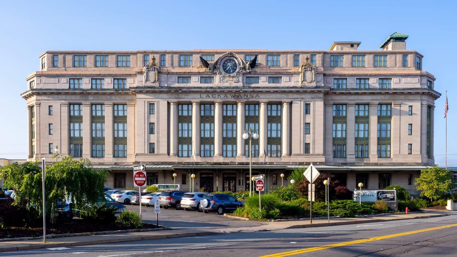 A six-storey Beaux-Arts station building with a clock and eagle on the cornice