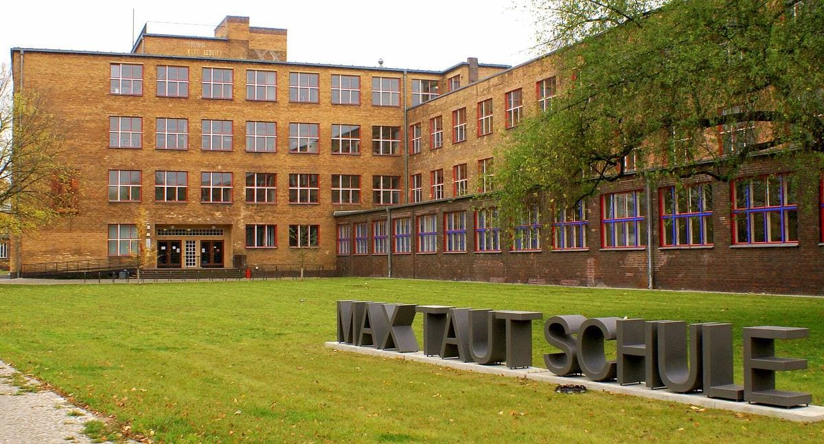 A long flat-roofed 1930s school building in yellow brick