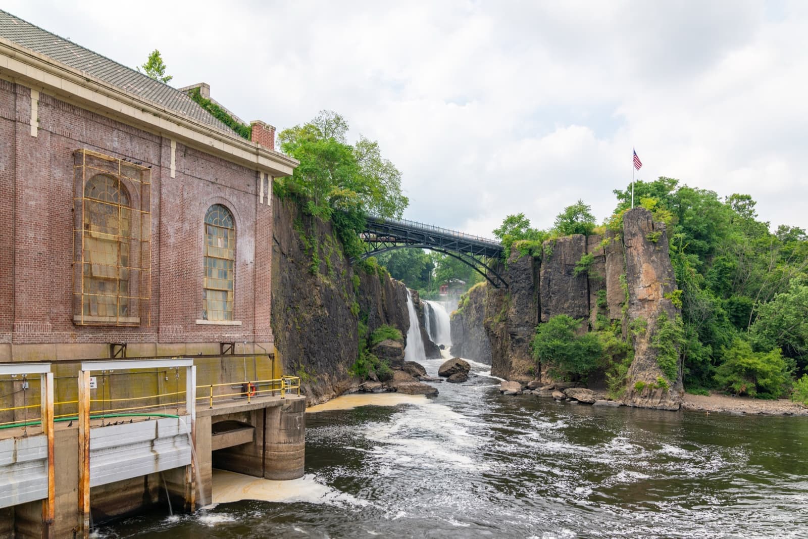 A wide waterfall pouring into a rocky gorge