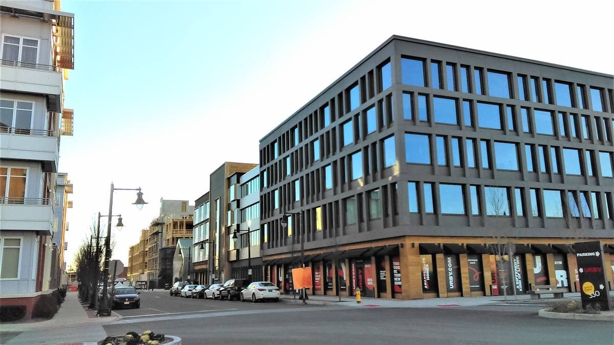 New brick and glass blocks along a wide street in Harrison