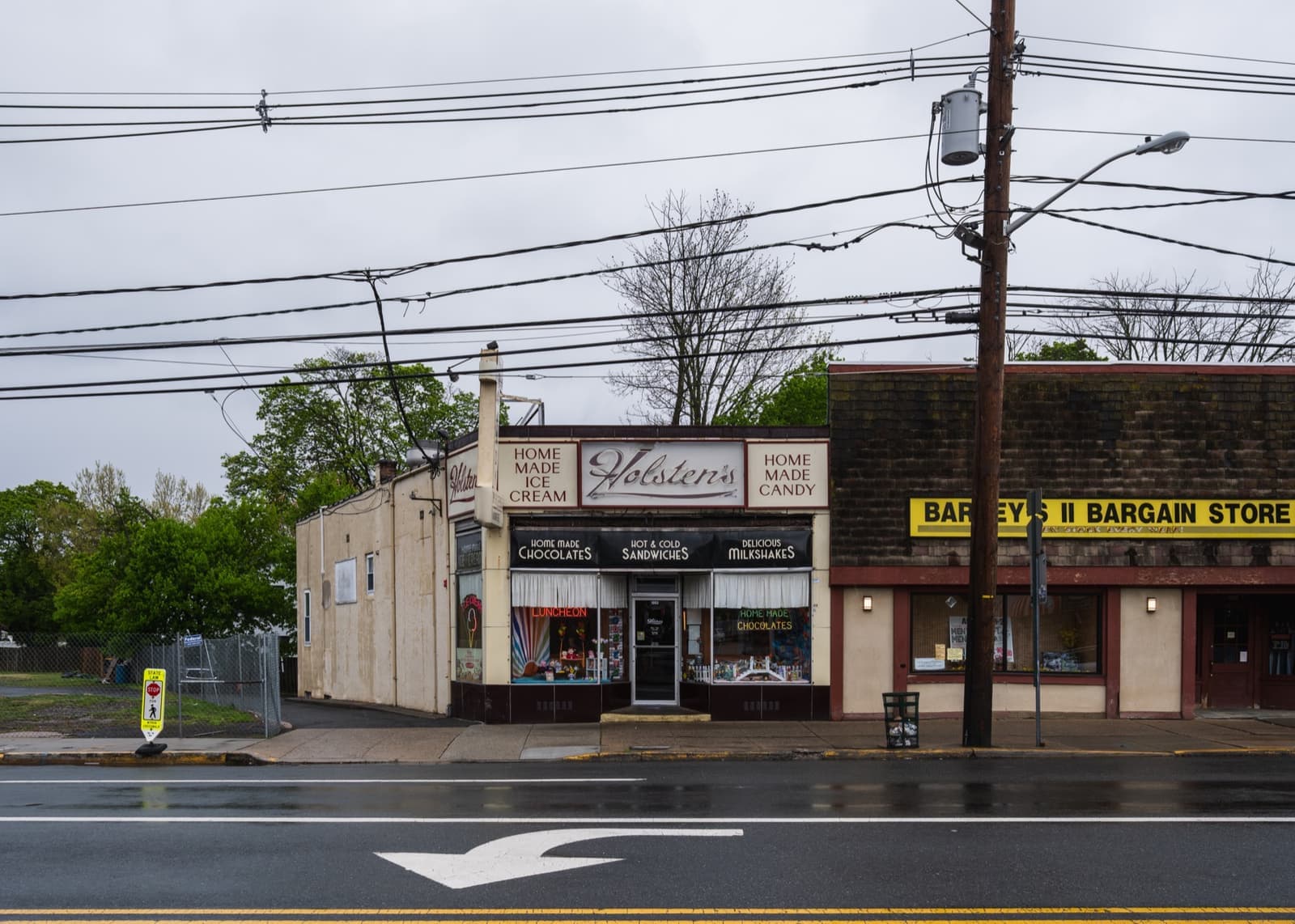 Holsten’s shopfront on a wet Broad Street under an overcast sky