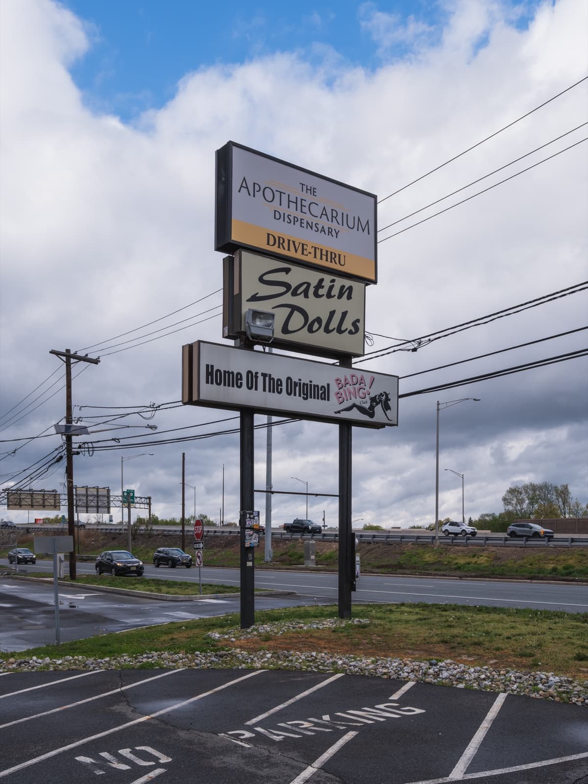 A roadside pole sign reading Home of the Original Bada Bing! Club
