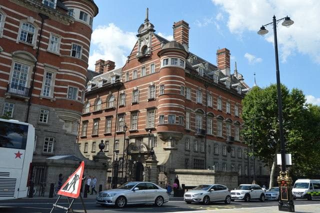 A red-and-white striped brick building with a round corner turret on Victoria Embankment