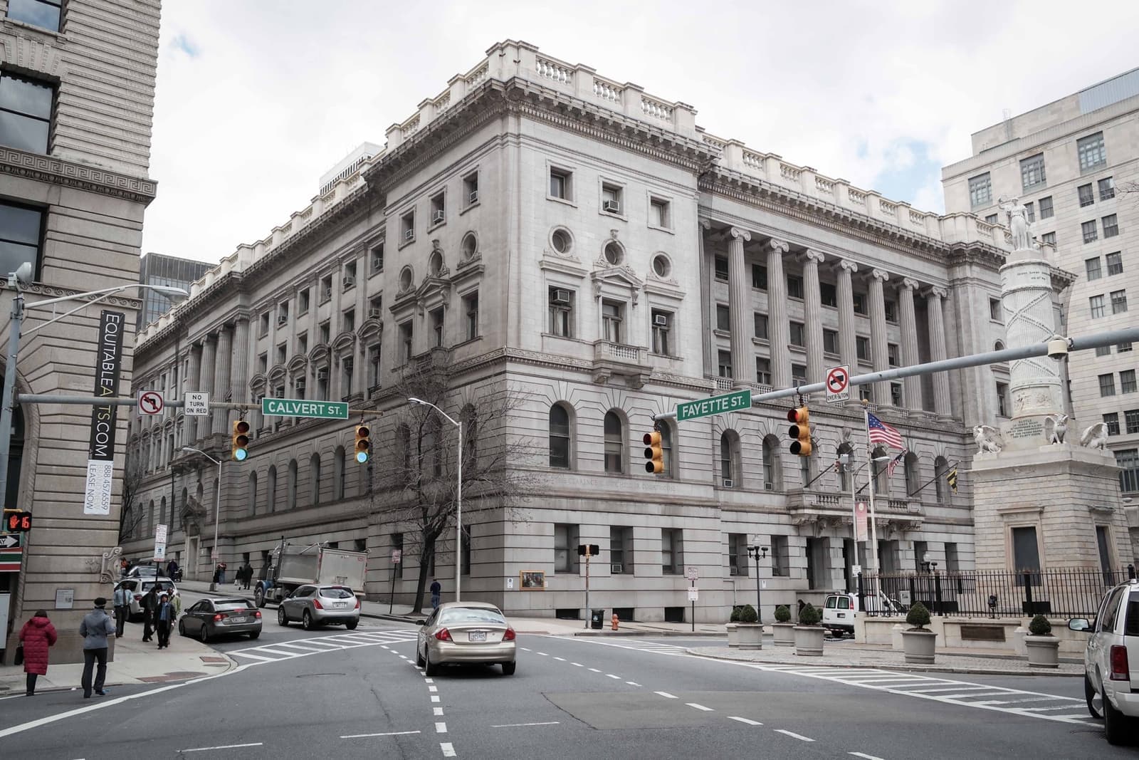 A grand neoclassical courthouse with tall columns along a downtown street