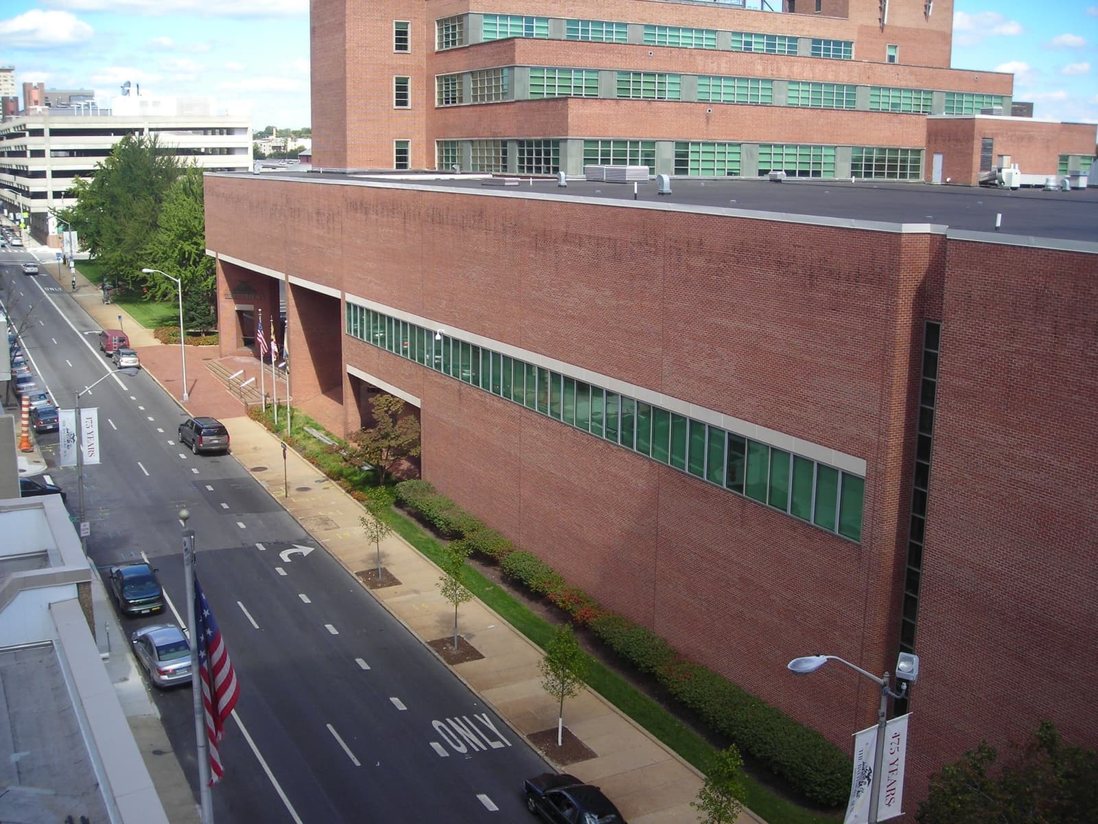 A long modern newspaper building seen from a raised walkway
