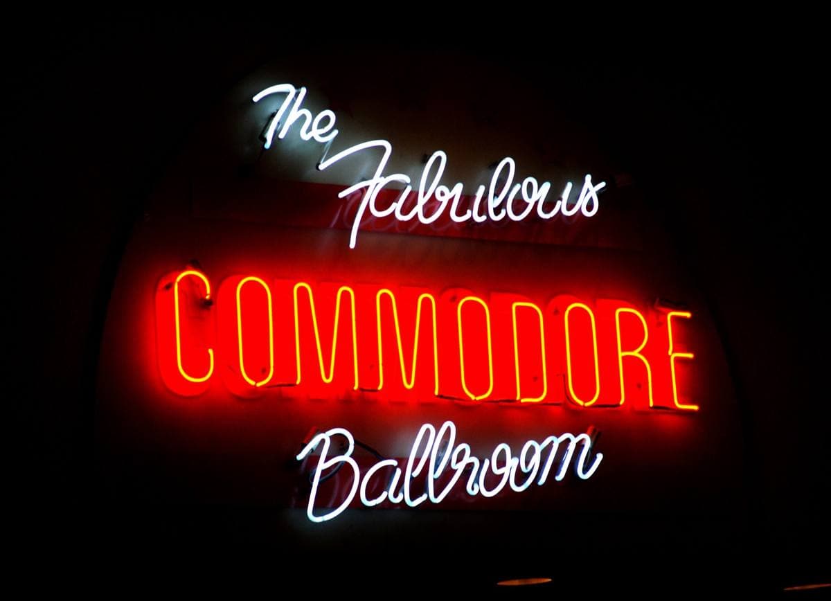 The neon sign of the Commodore Ballroom glowing at night
