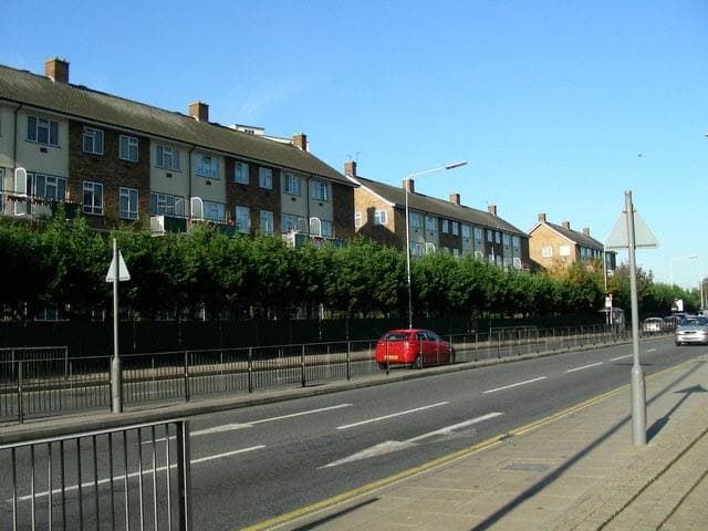 A dual carriageway ring road with railings and trees
