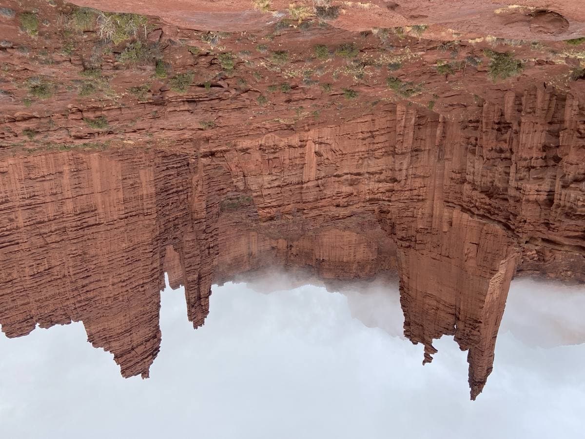 Red rock towers above a dirt road