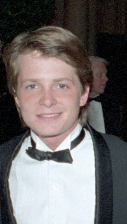 A smiling young man in a dinner jacket and bow tie