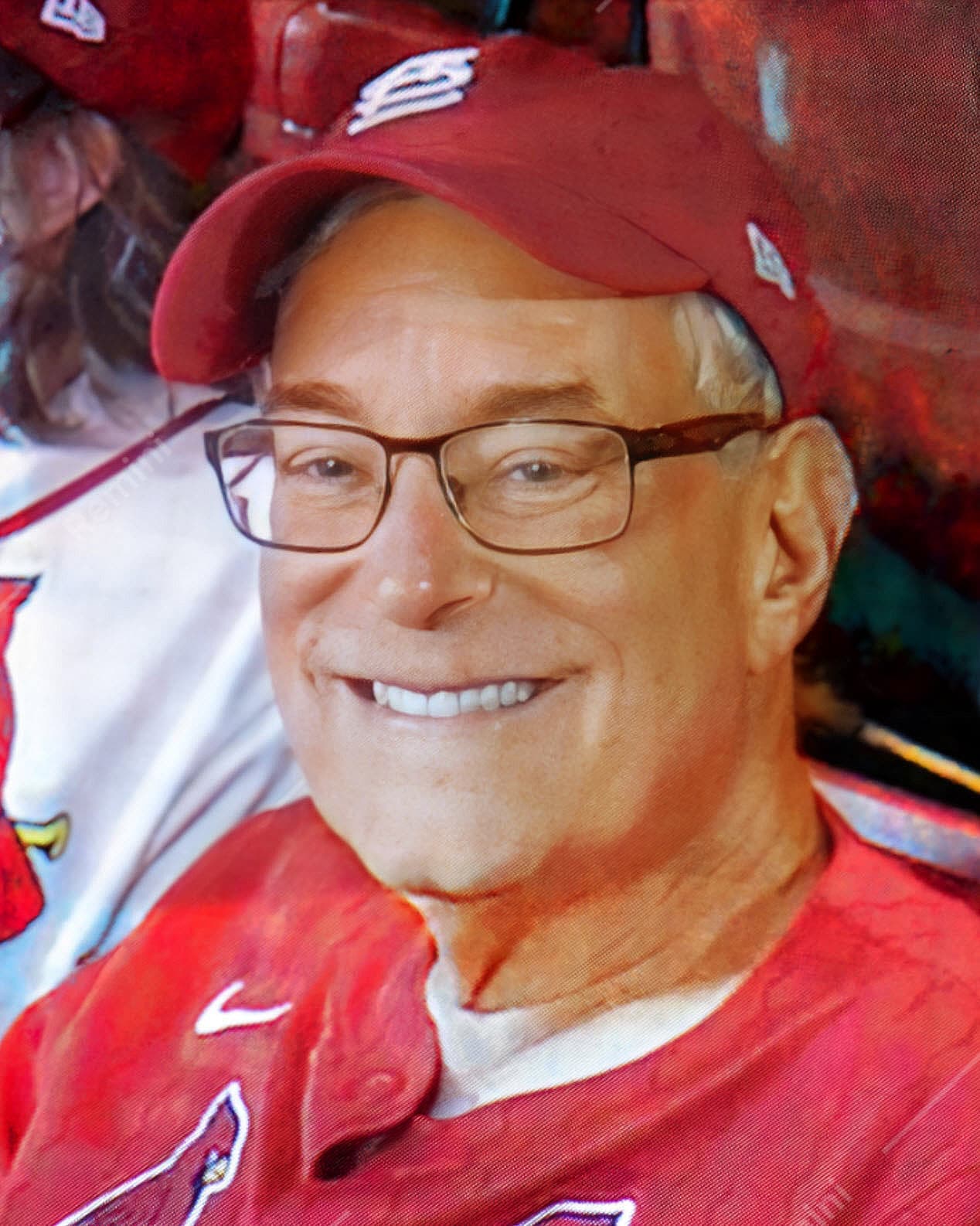 Bob Gale in a red baseball cap and glasses, smiling