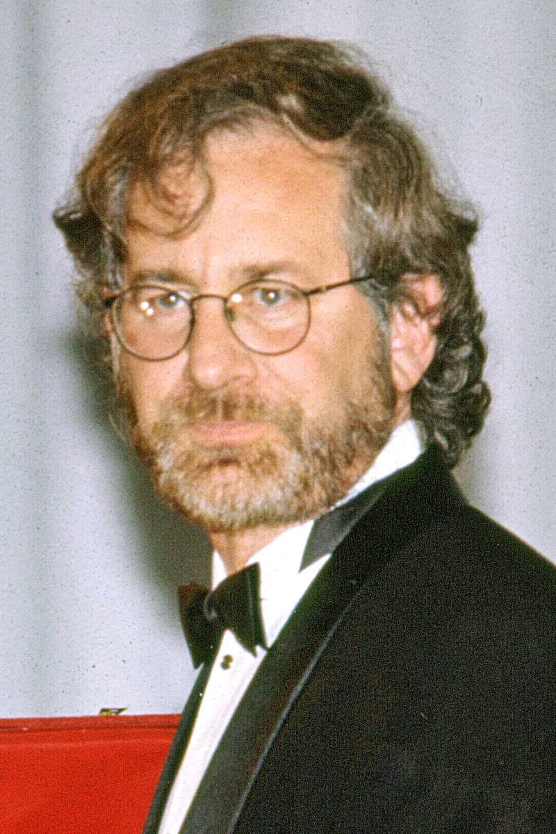 Steven Spielberg, bearded, in round glasses and a bow tie
