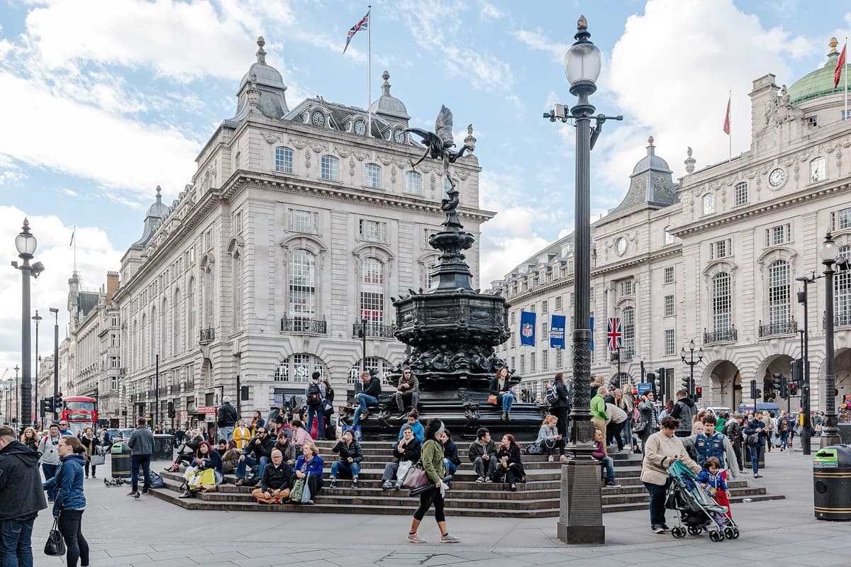 Piccadilly Circus with the fountain, crowds and lit advertising screens