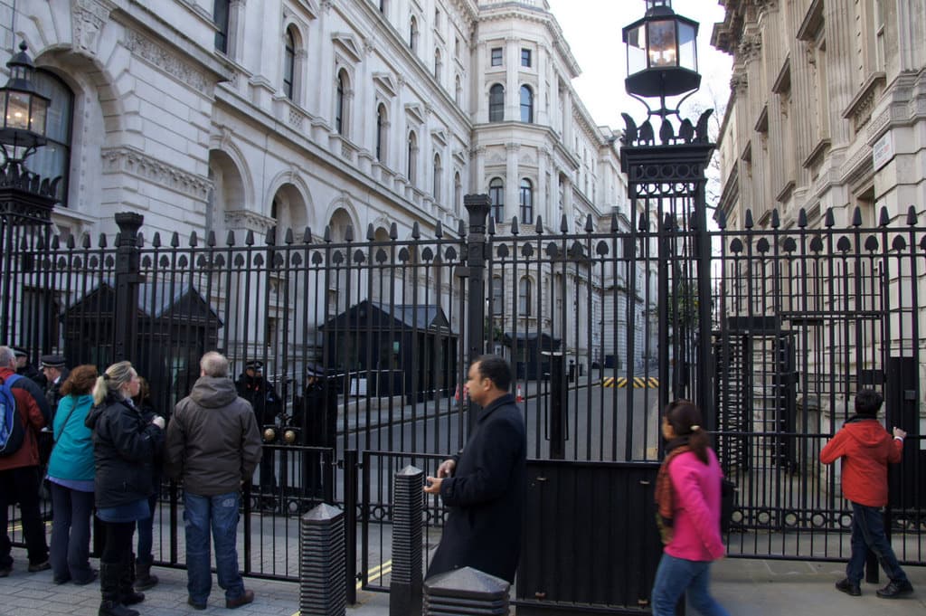A wide street with gates and government buildings at the end of Downing Street