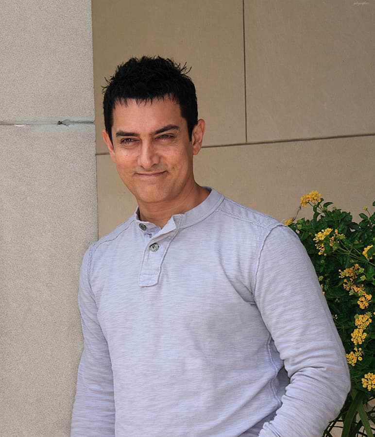 A smiling man in a dark jacket at a festival event