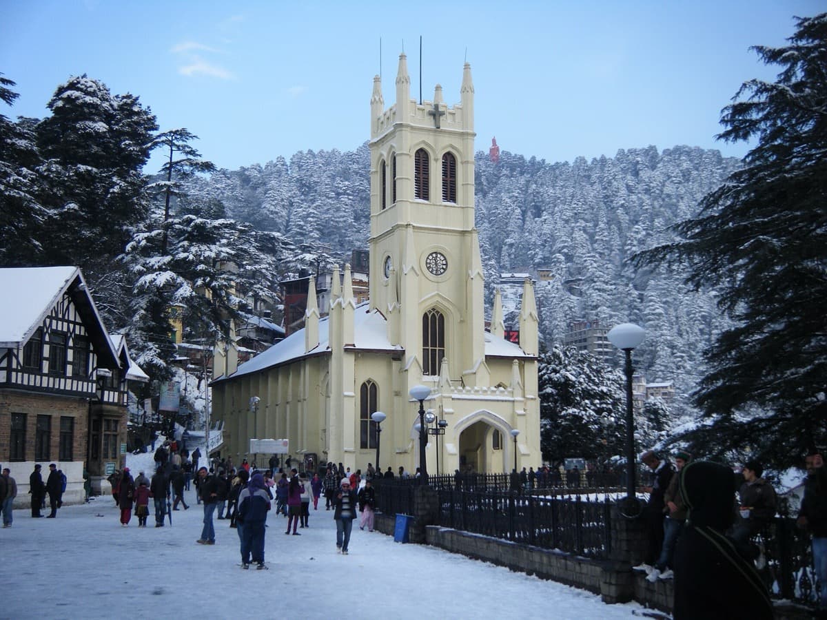 A pale yellow Gothic church with a square tower
