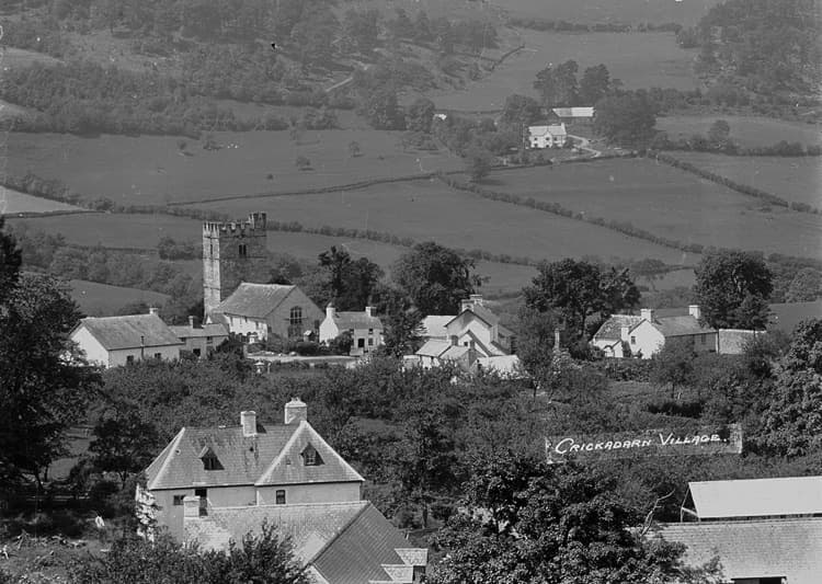 A small Welsh village of whitewashed houses on a hillside lane