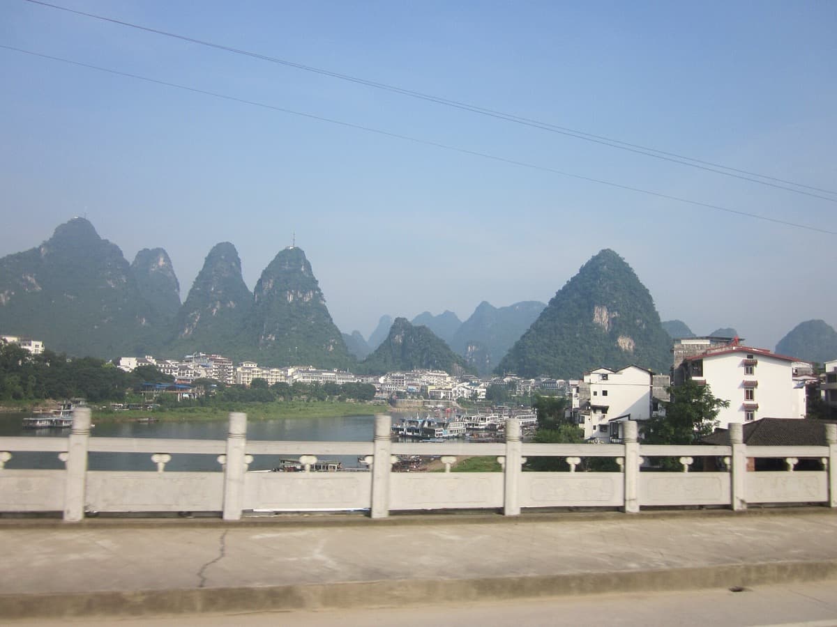 Steep green limestone hills along a river