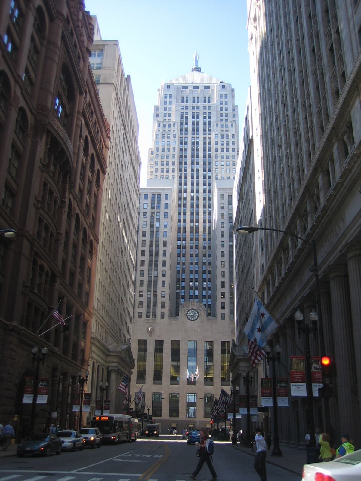 A canyon of tall buildings along LaSalle Street ends at a stepped Art Deco tower