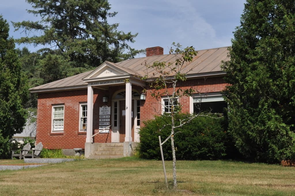 A small stone library building with a pitched roof