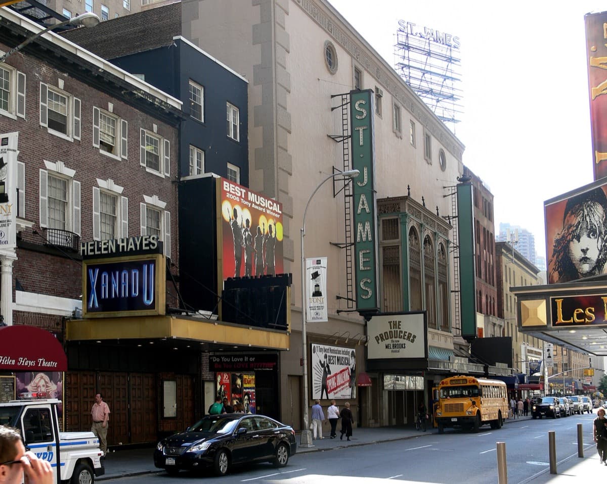 A row of Broadway theatre fronts on West 44th Street with canopies