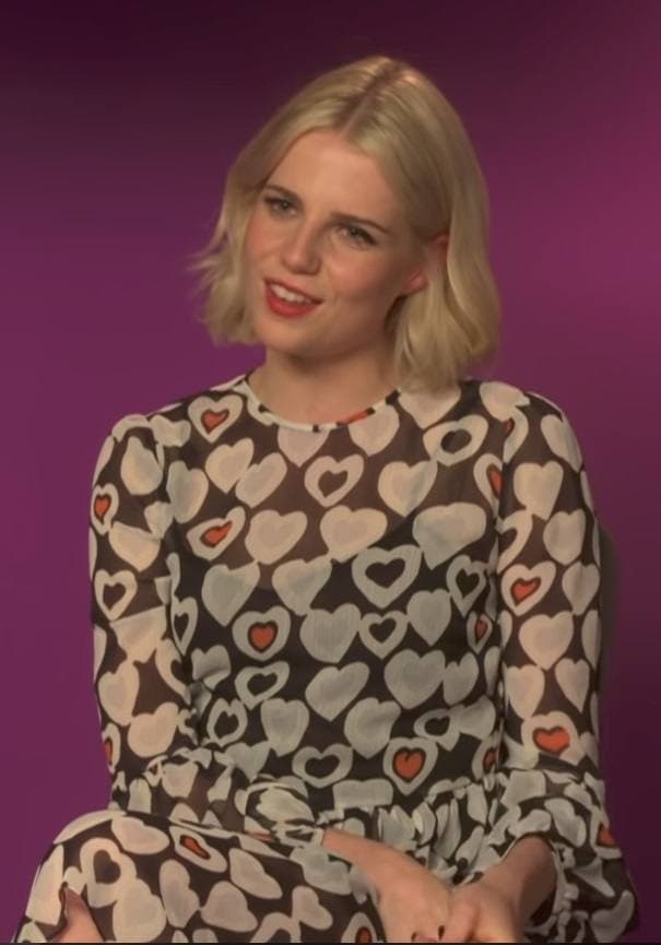 Lucy Boynton smiling on a television set