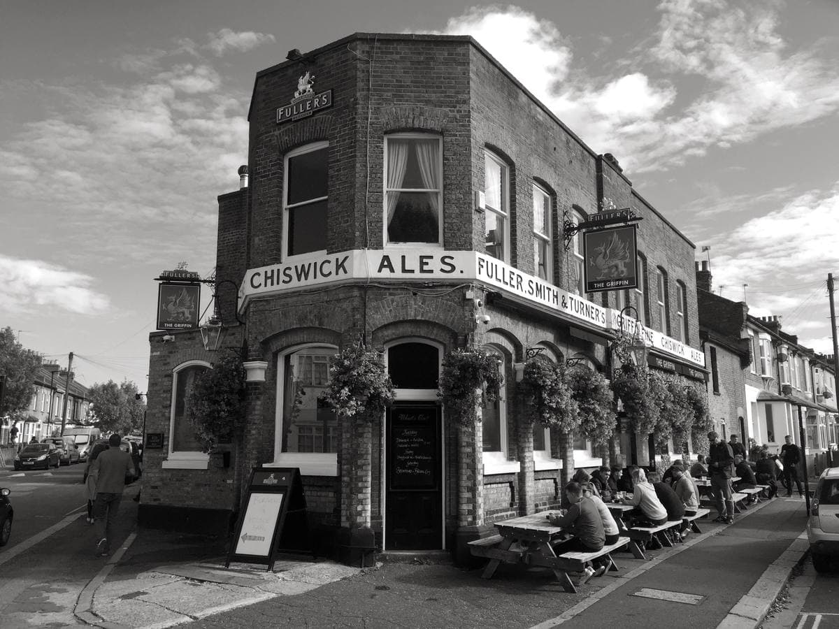 A corner pub with hanging baskets on a residential street