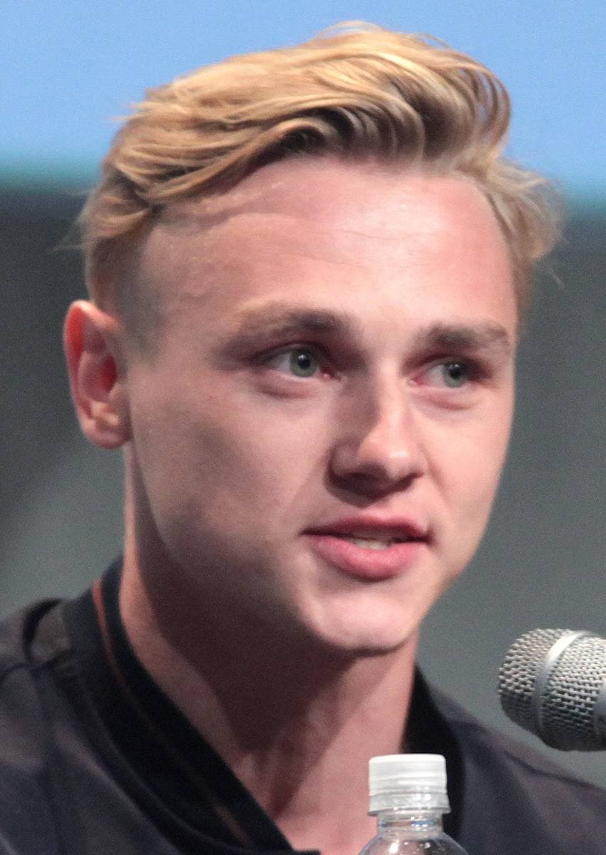 Ben Hardy speaking into a microphone at a panel