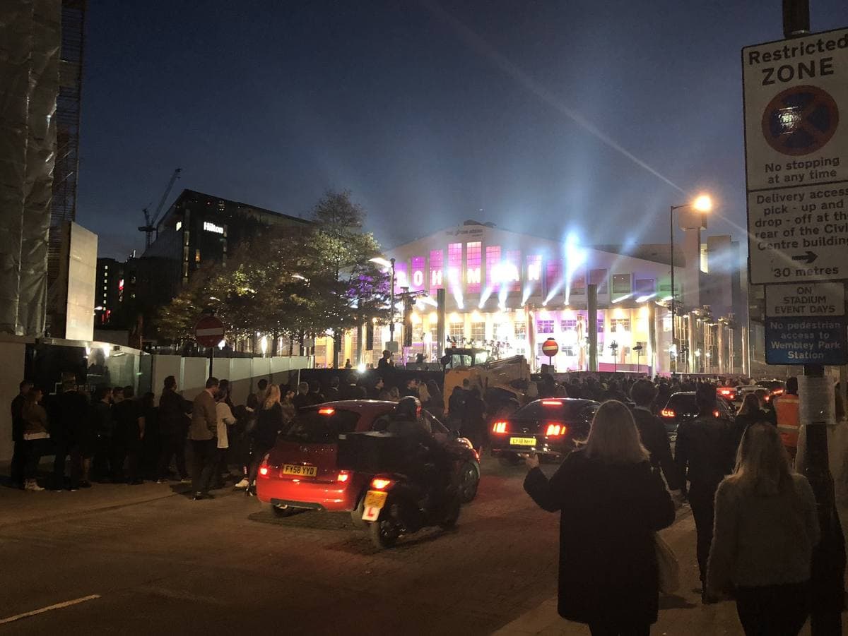 The front of Wembley Arena at dusk with premiere banners