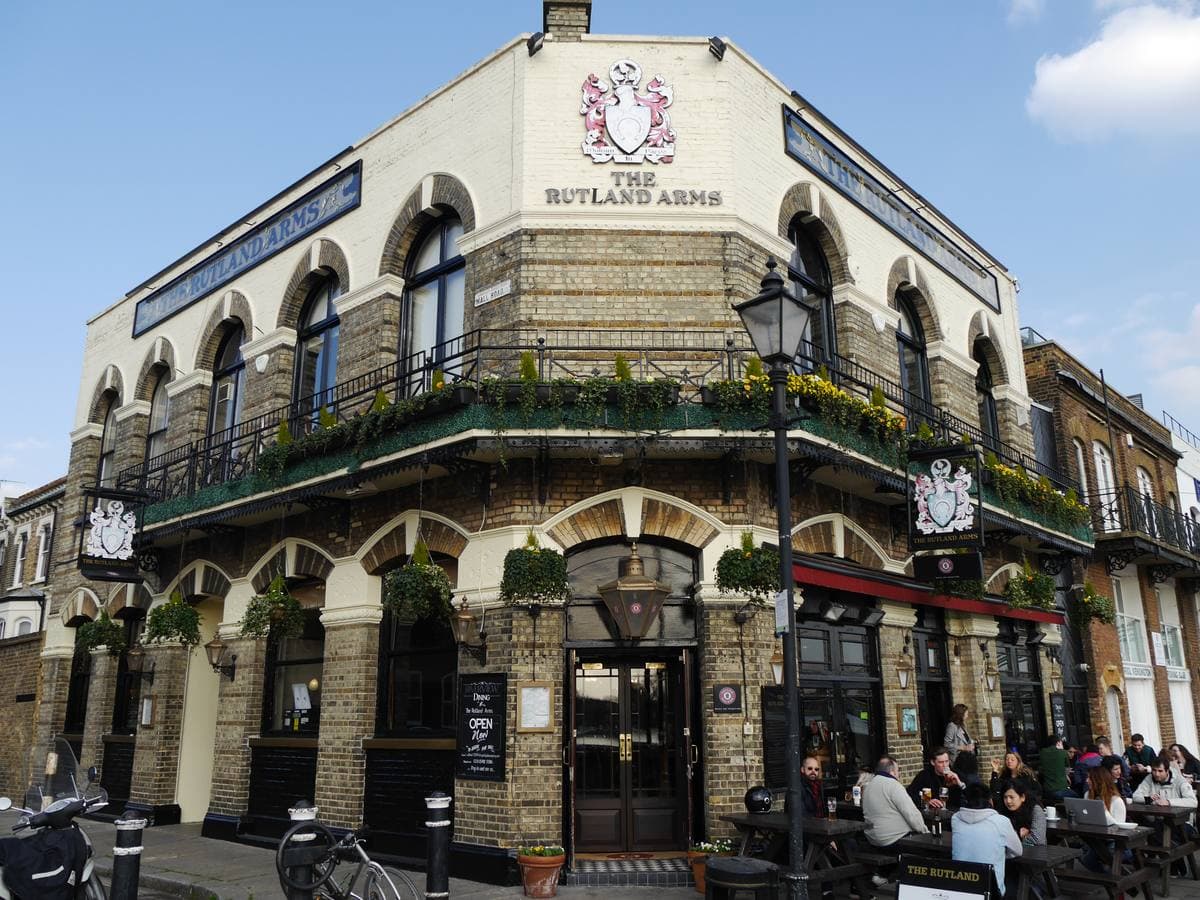 A riverside pub with a balcony beside the Thames path