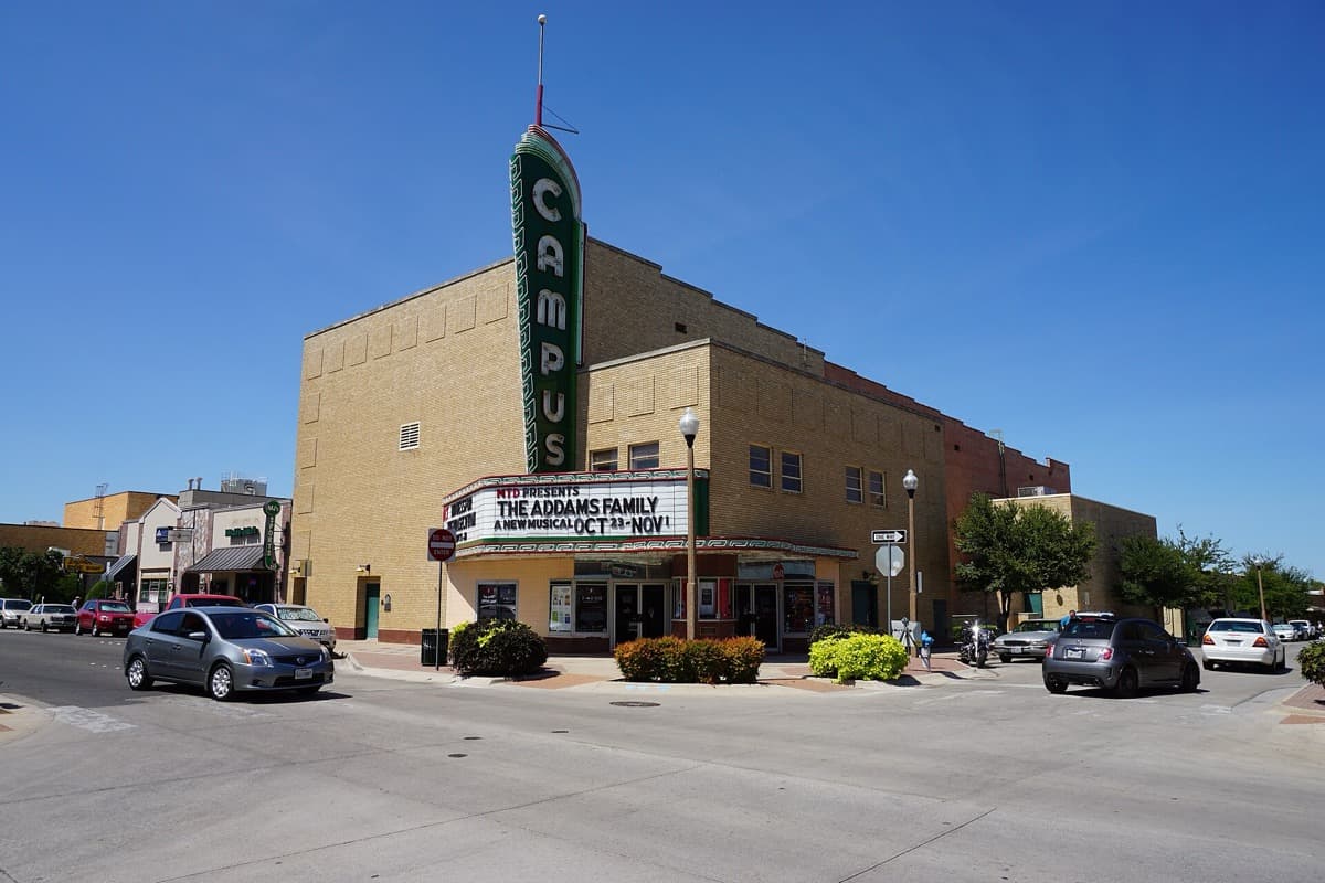 The front of a cinema with a tall vertical sign