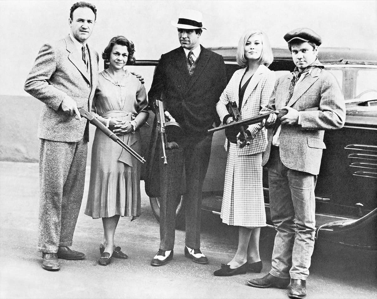 Five actors in 1930s clothes posed together in a studio publicity photograph