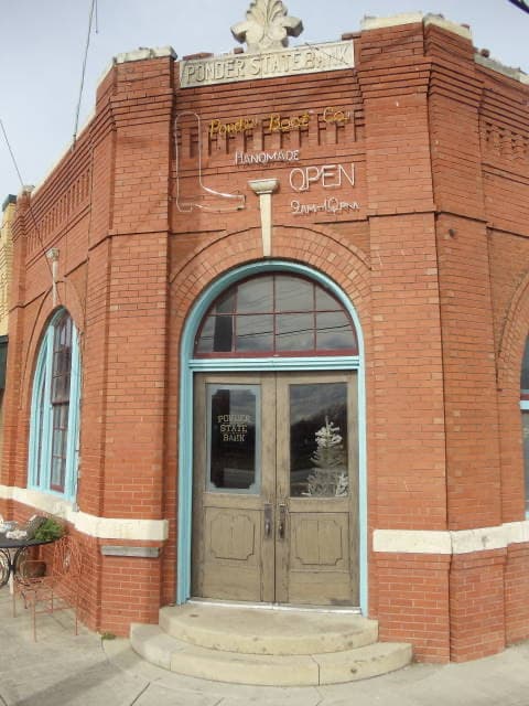 A small brick bank building with a flat front on a Texas street