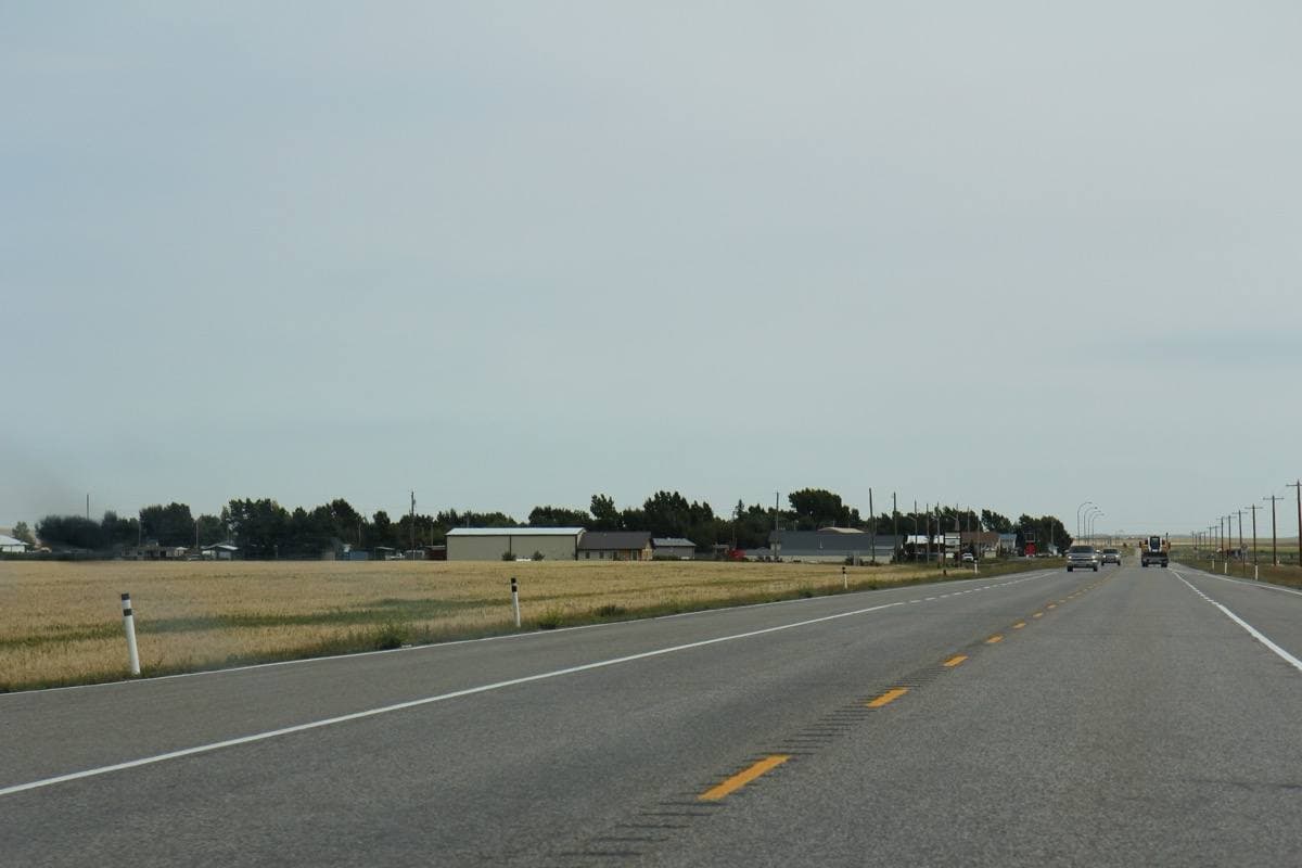 A small prairie village spread along a highway under a big sky
