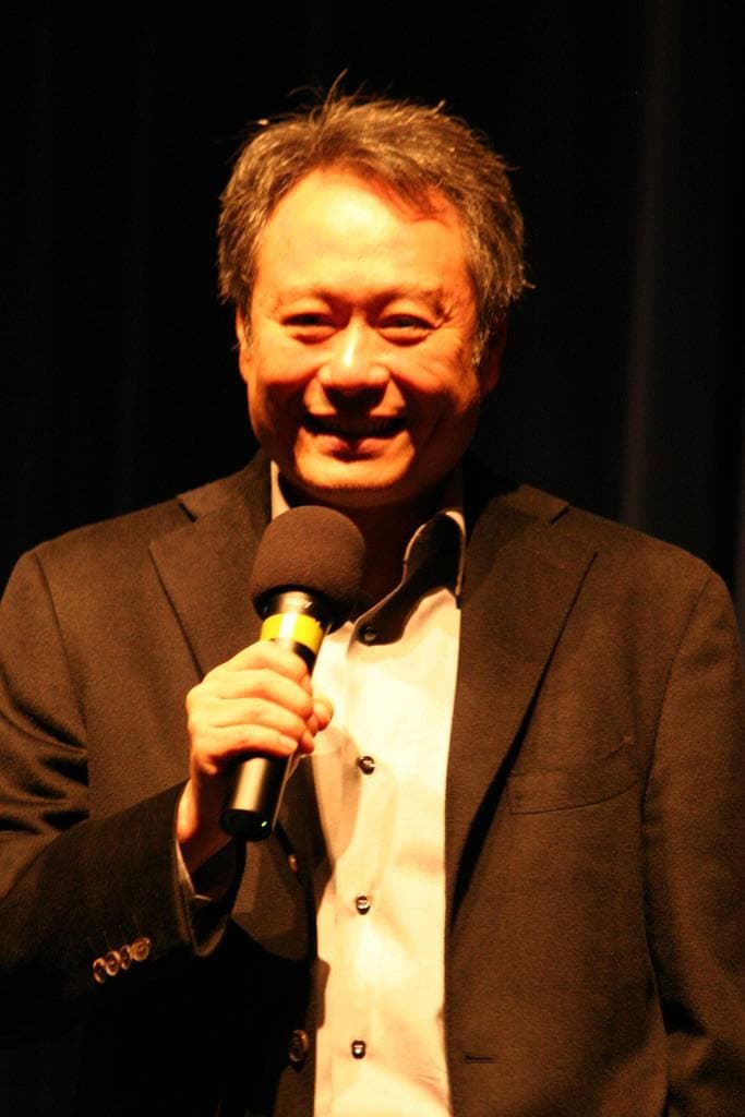 Ang Lee in glasses and a dark jacket, smiling
