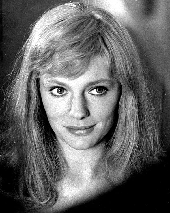 Black-and-white portrait of Jacqueline Bisset with long hair, half smiling