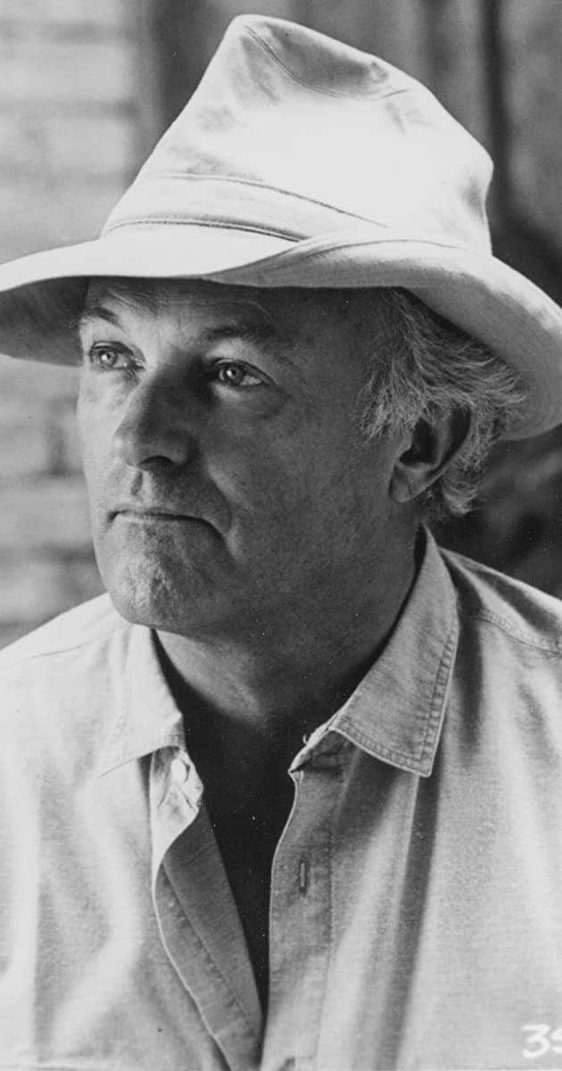 Black-and-white portrait of Peter Yates in a pale hat, looking to one side