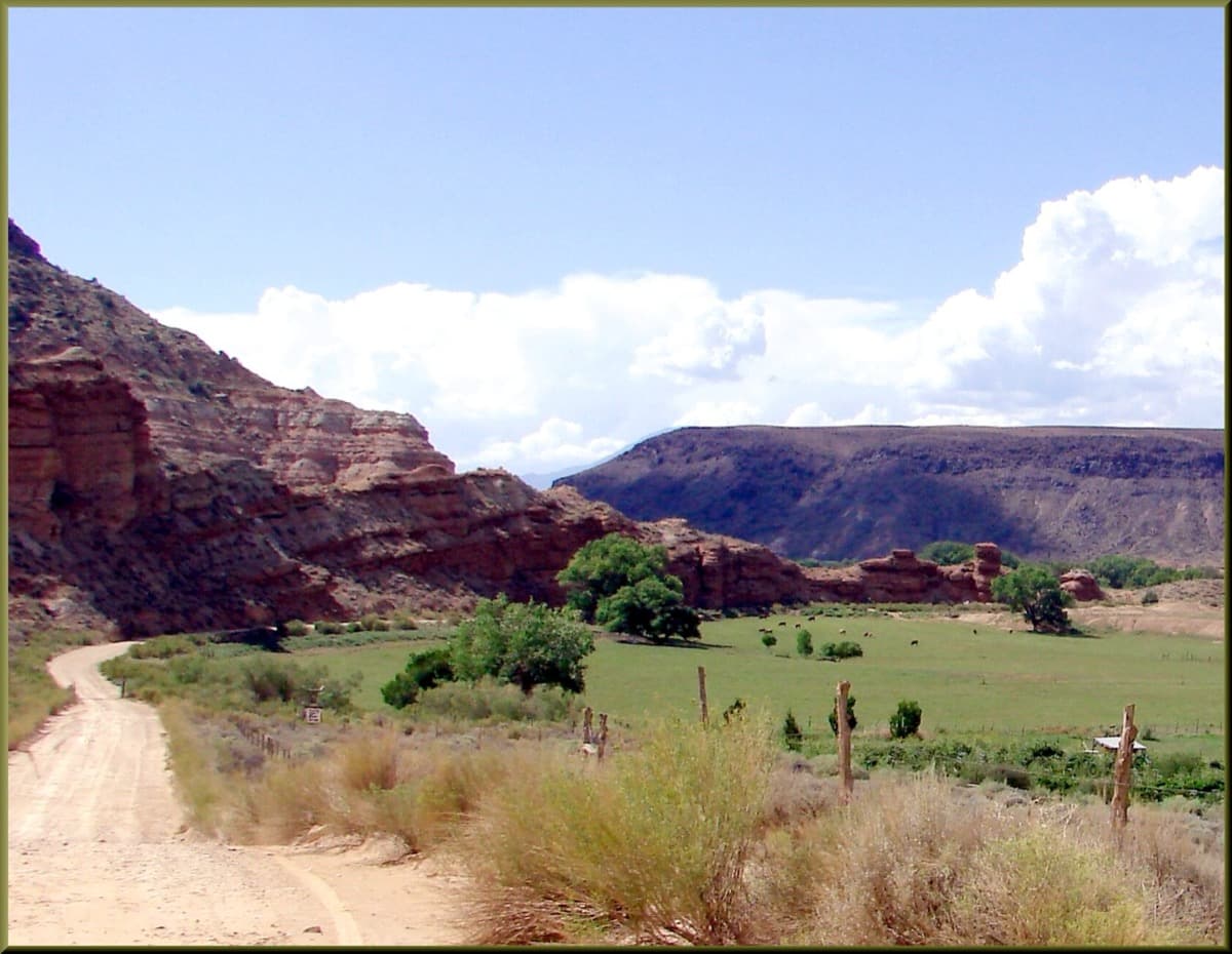 Grafton, Utah, an unpaved road running between old farm buildings under a pale sky.