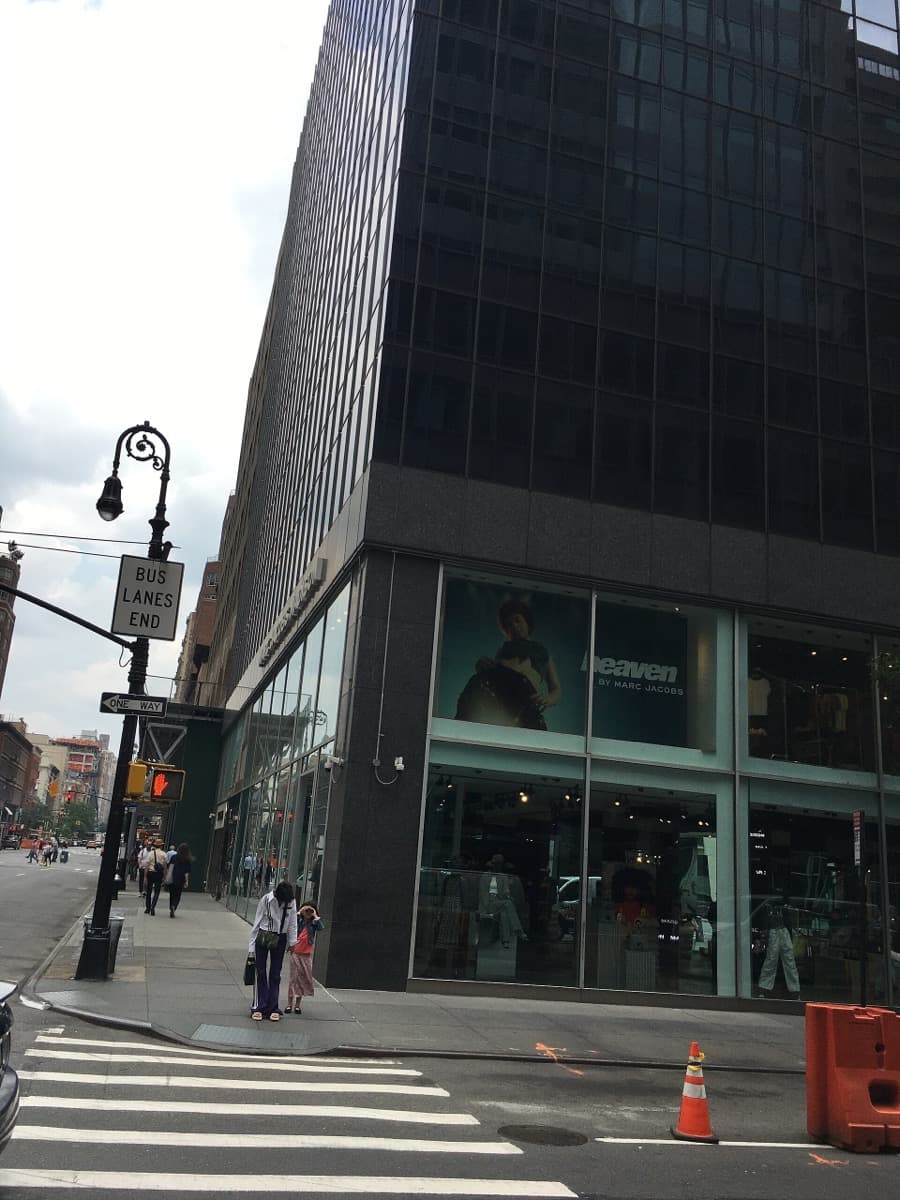 A tall building on the corner of a Manhattan avenue and a side street