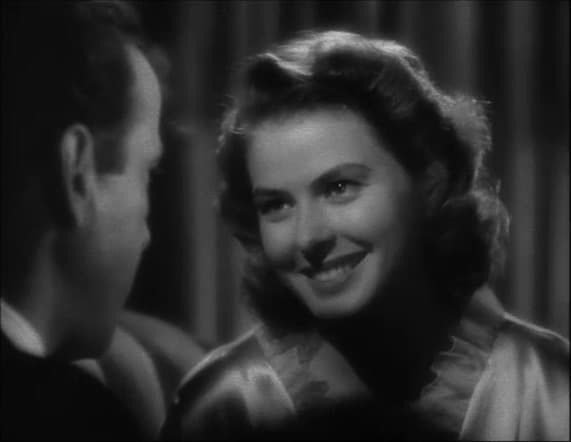 Ingrid Bergman smiles in soft light, Bogart’s shoulder in the foreground