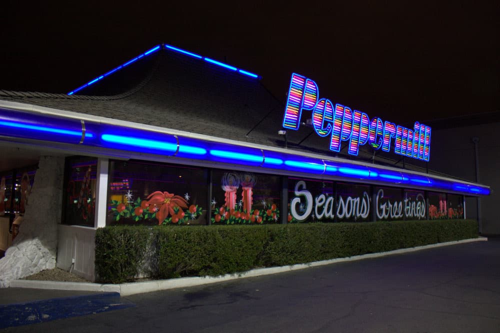 The low Peppermill restaurant building with its sign and entrance