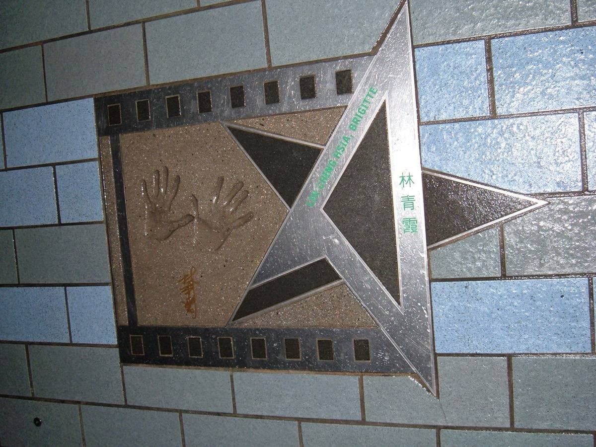 A pair of handprints and a signature set in a bronze plaque