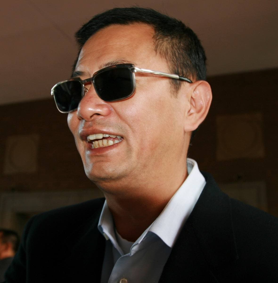 Wong Kar-wai in dark glasses and a dark jacket